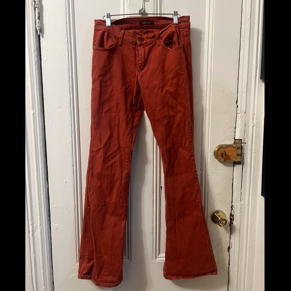Rust colored bell bottomed James Jeans. Size 29